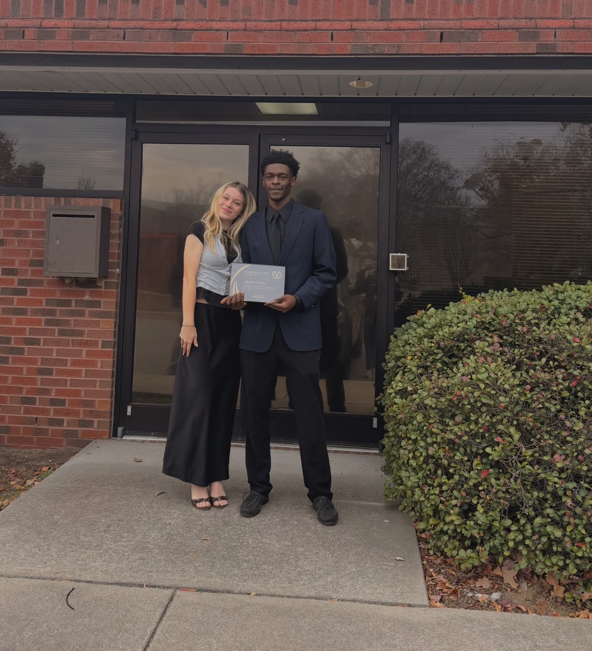 Envision Marketing team members holding an achievement certificate